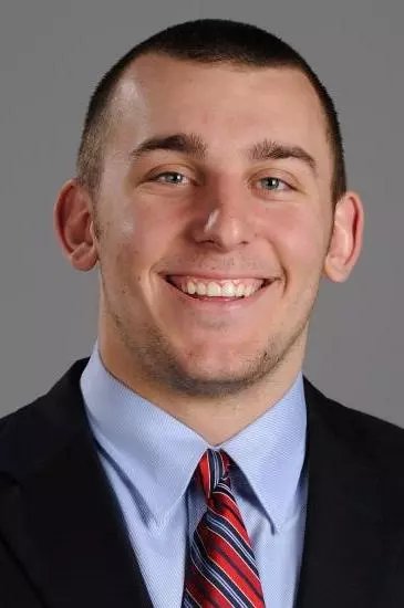 Hirsch in a suit and striped tie