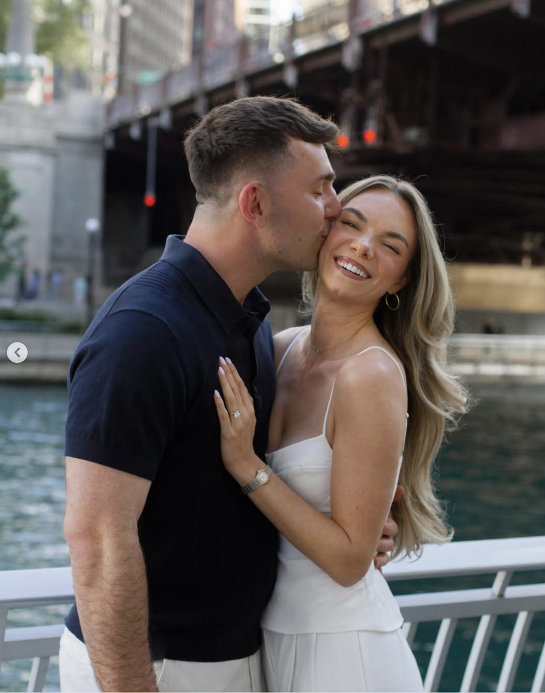 Hirsch kissing Alli on the cheek by the river