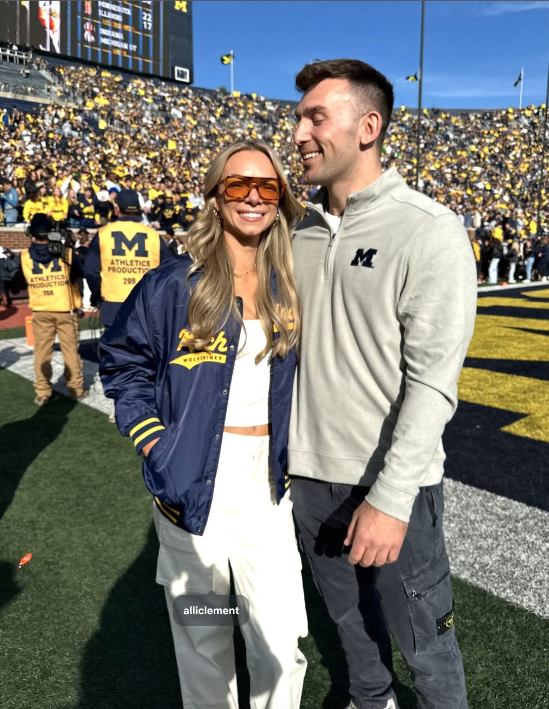 Alli in a Michigan jacket with Hirsch at Michigan Stadium